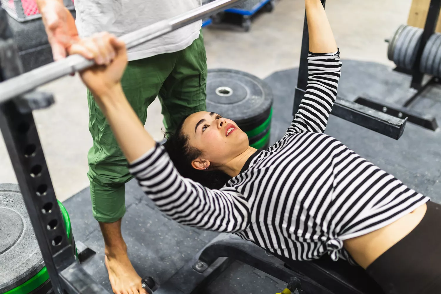 woman lifting weights at gym